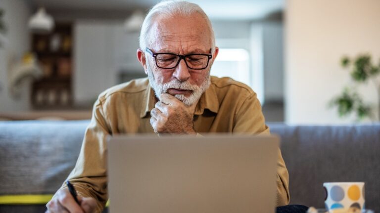 senior man is using laptop