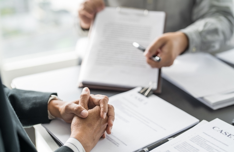 lawyer is reviewing with documents with the client
