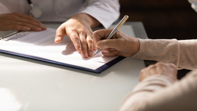 woman signing documents