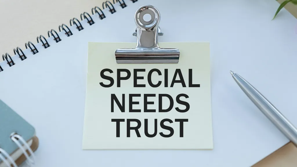 Metal clip holding a note with "SPECIAL NEEDS TRUST" text on a white desk.